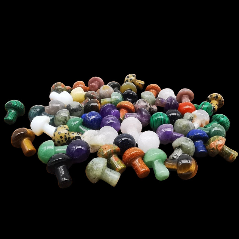 Assorted colored gemstones on a wooden surface