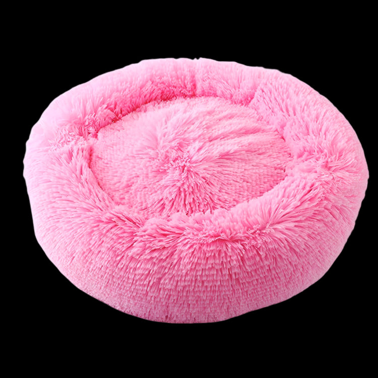 Pink fluffy pet bed on a light gray background