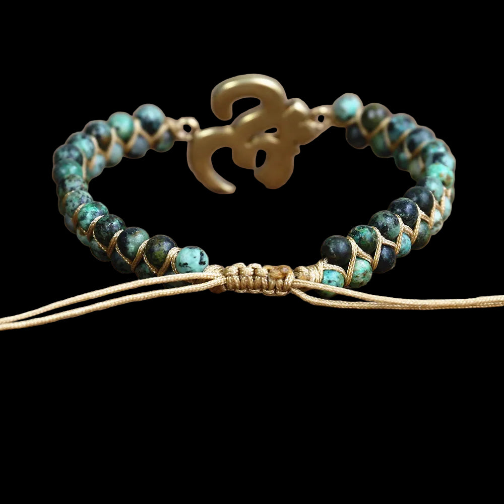 Beaded bracelet with gold accents on a wooden surface