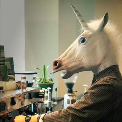 Person wearing a unicorn mask in a laboratory setting