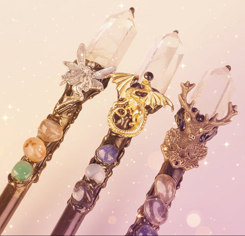 Decorative hair stick with crystals and gemstones on a pink and purple gradient background