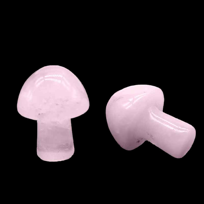 Two pink crystal mushroom-shaped objects on a white background