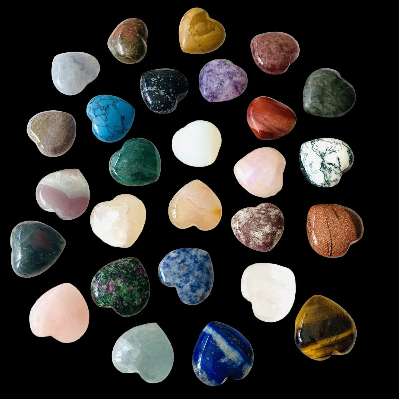 Collection of heart-shaped stones in various colors on a white background