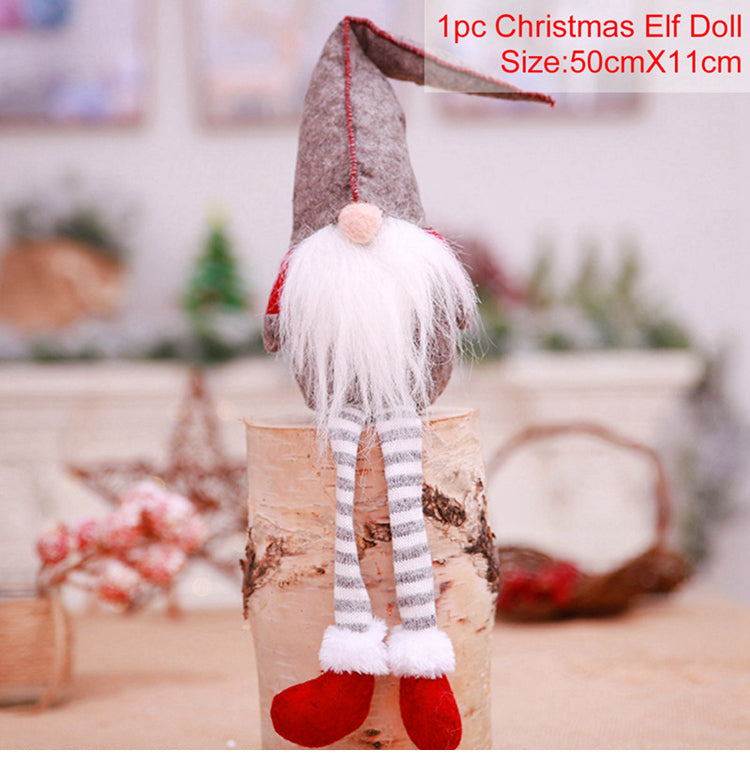 Christmas elf doll with long striped legs on a wooden block, blurred background