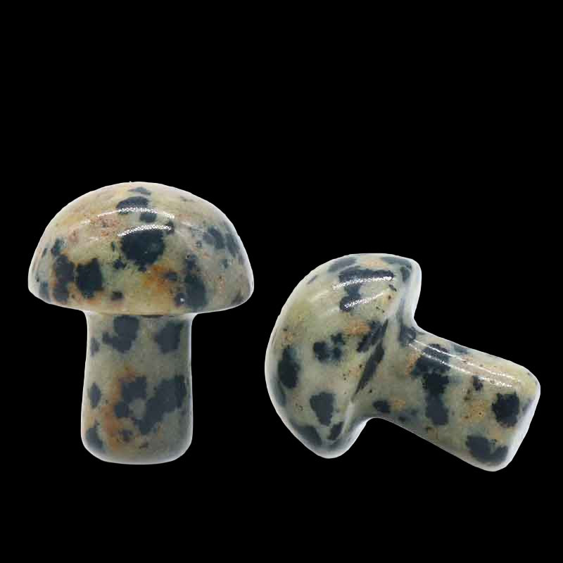 Two ceramic mushroom-shaped beads with a speckled pattern on a white background