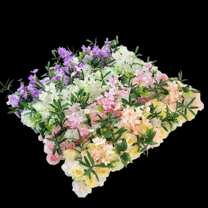 Heart-shaped arrangement of colorful flowers on a white background
