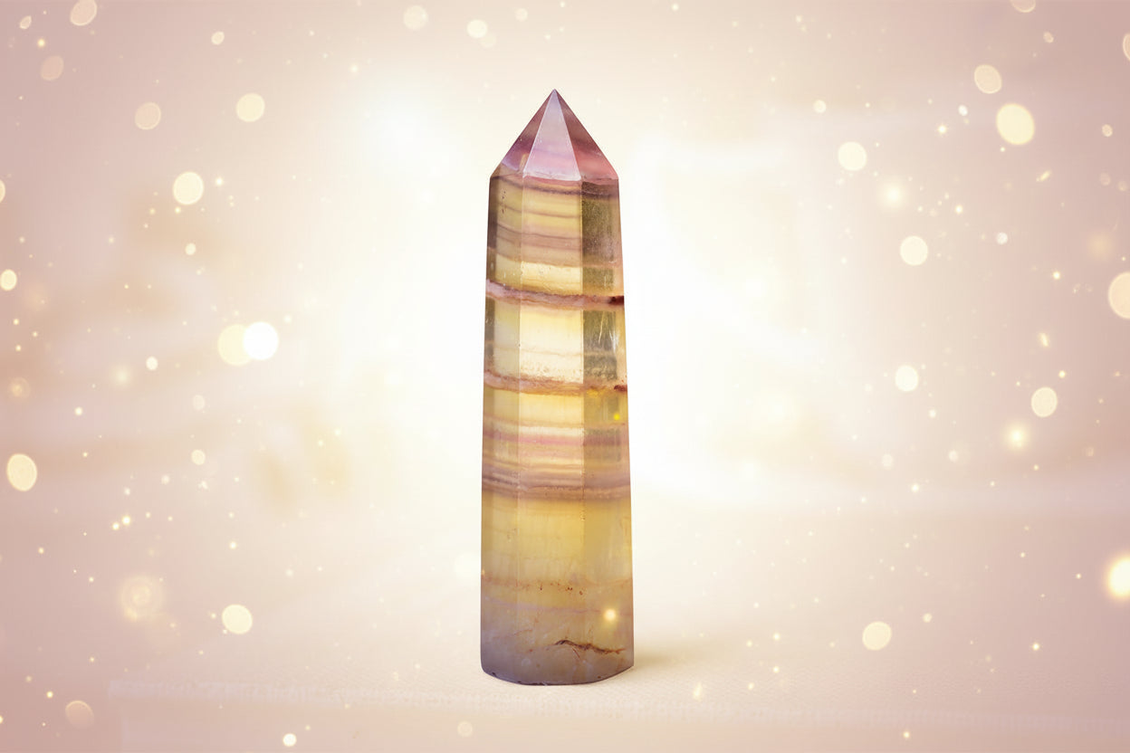 Multicolored crystal tower on a light fabric background