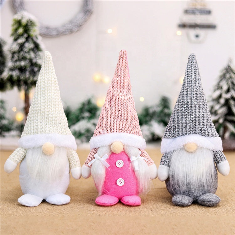 Three decorative gnomes with knitted hats in a festive setting.