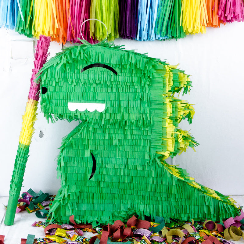 Green pinata with colorful tassels on a white background