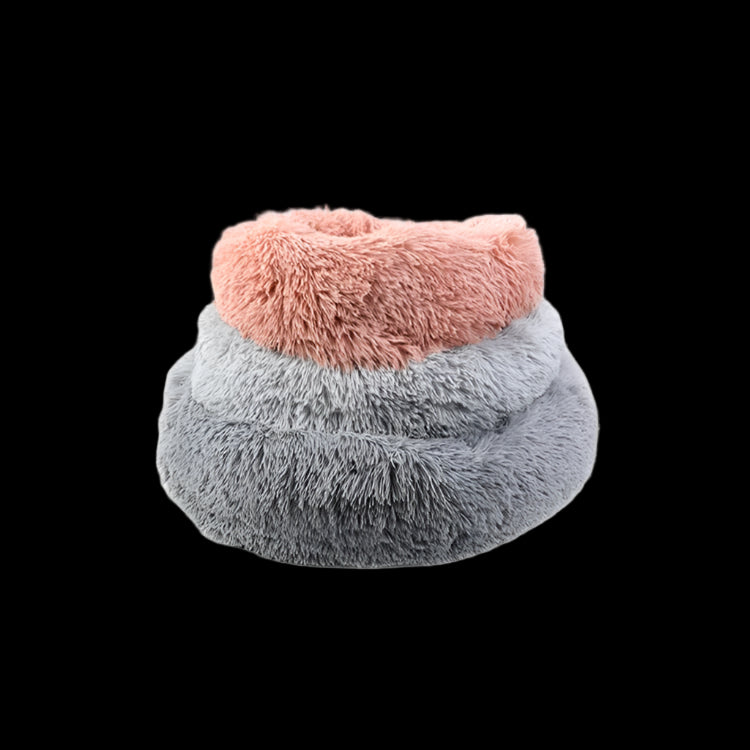 Fluffy pet bed with pink top and gray bottom on a white background