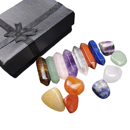 Set of colorful crystals on a dark surface with a black gift box.