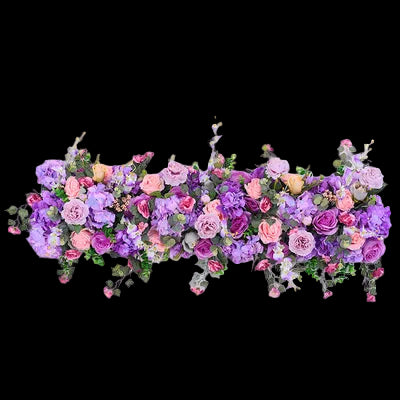 Floral arrangement with purple, pink, and green flowers on a white background