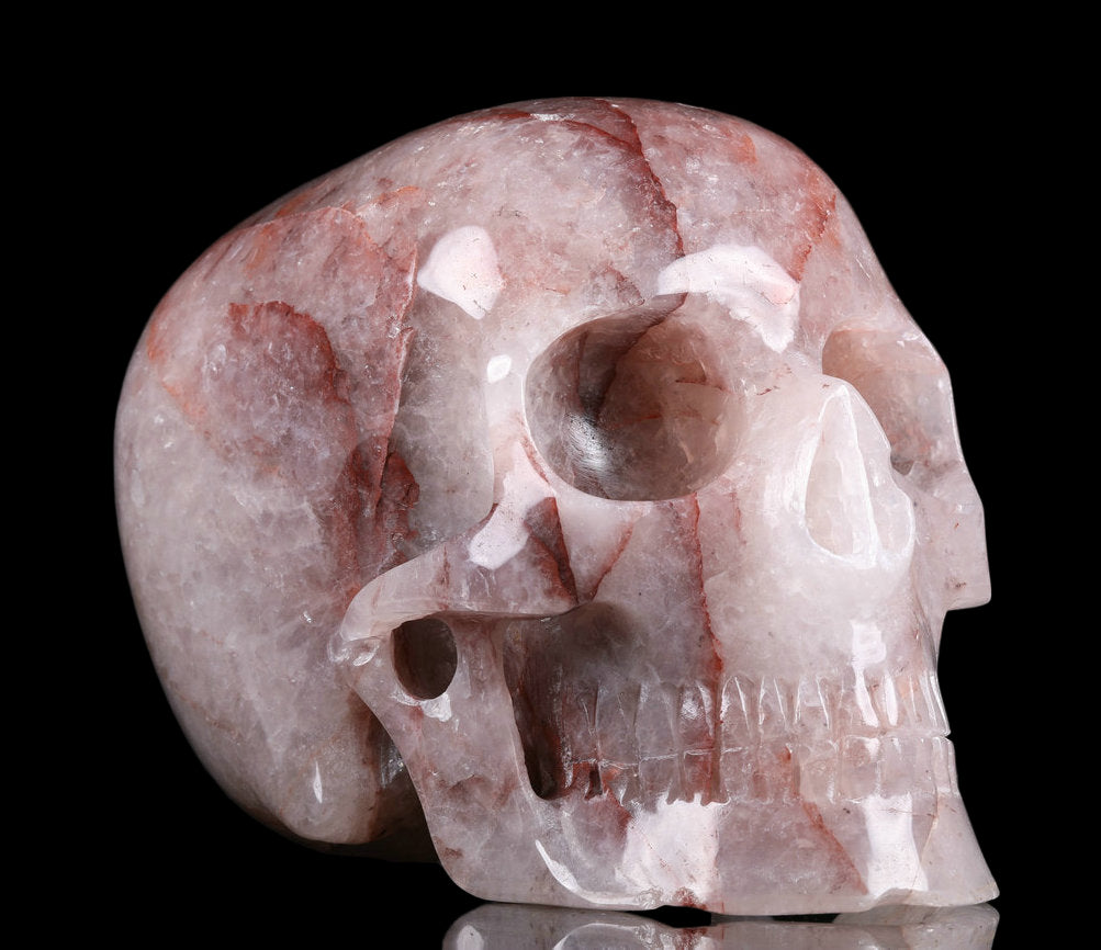 Carved stone skull on a black background