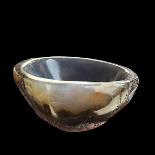 Hand holding a small agate bowl with more bowls in the background