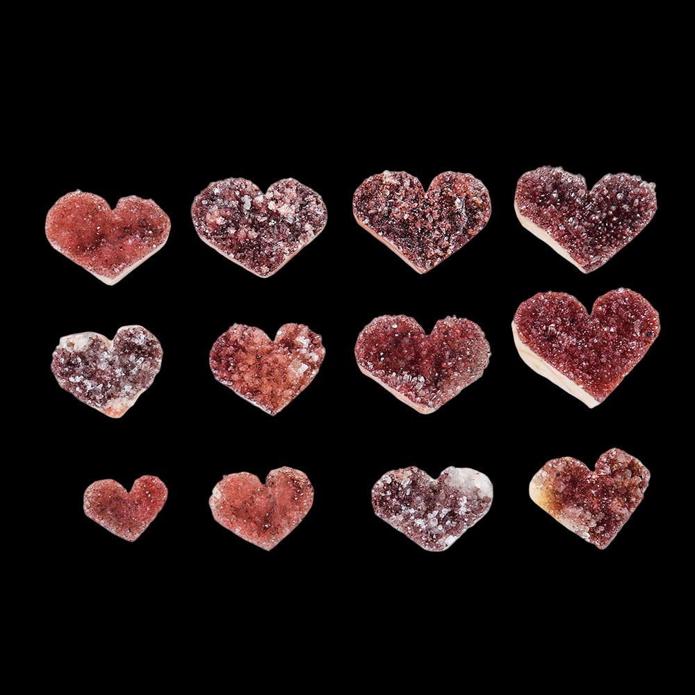 Heart-shaped crystal stones arranged in a grid on a white background