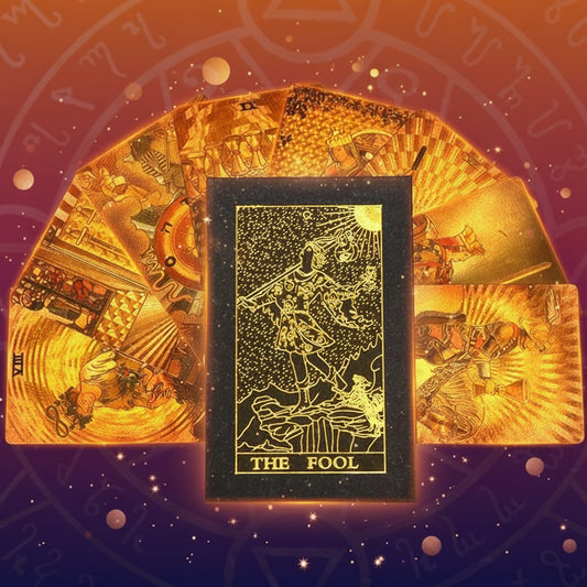 Gold tarot card with 'The Fool' on a black background with astrological symbols