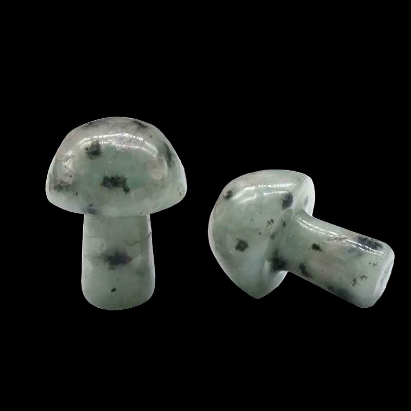 Two ceramic mushroom-shaped objects on a white background
