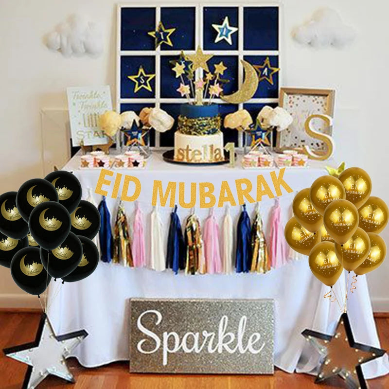 Decorated table with 'Eid Mubarak' and 'Sparkle' signs, balloons, and a cake.