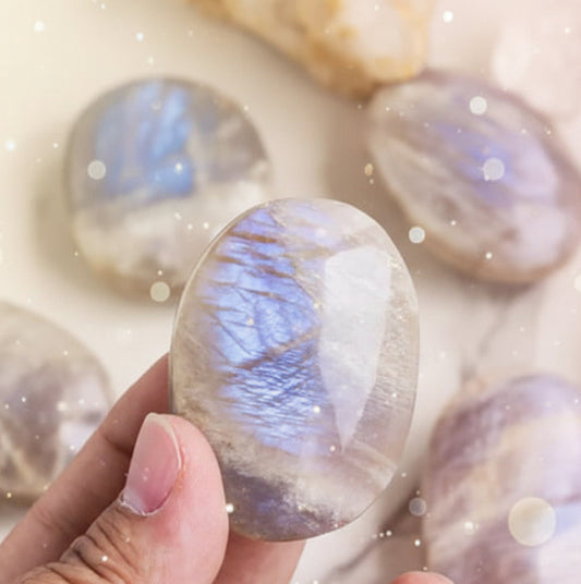 Hand holding a marbled stone with other stones in the background