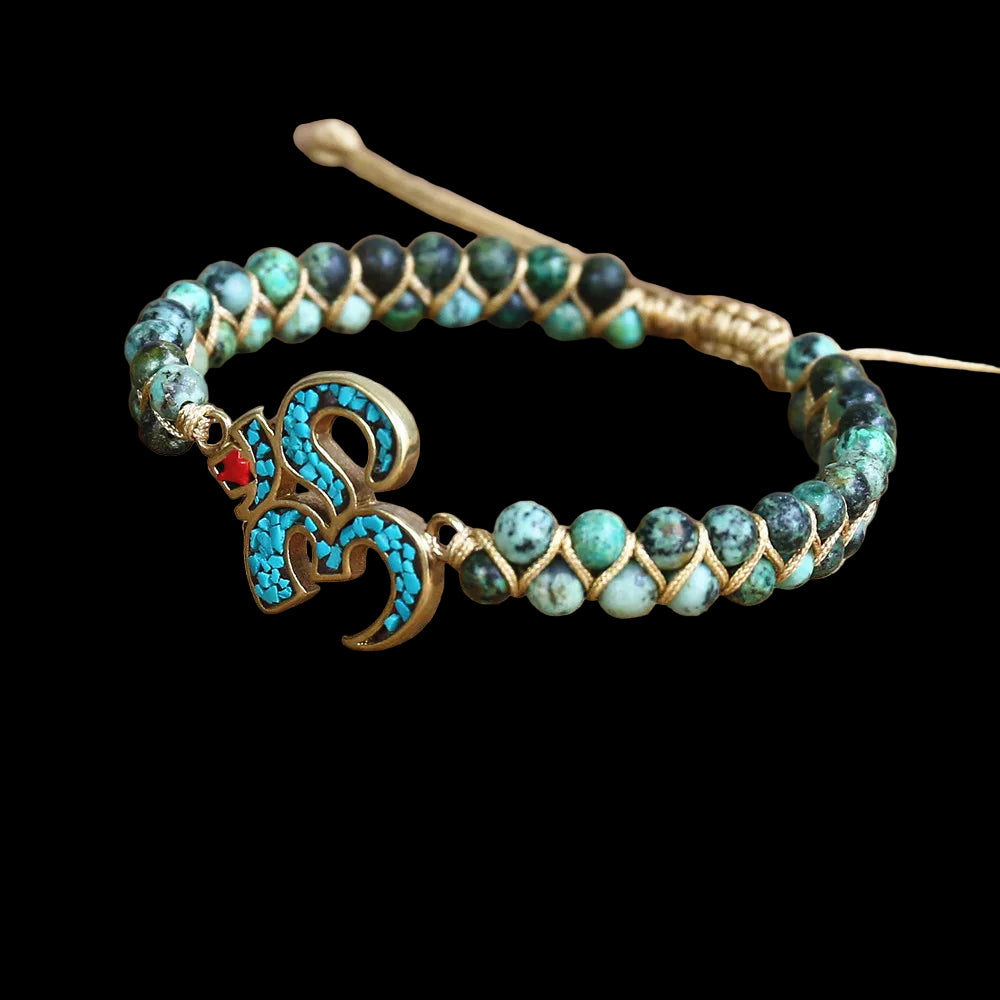 Beaded bracelet with a decorative clasp on a wooden surface