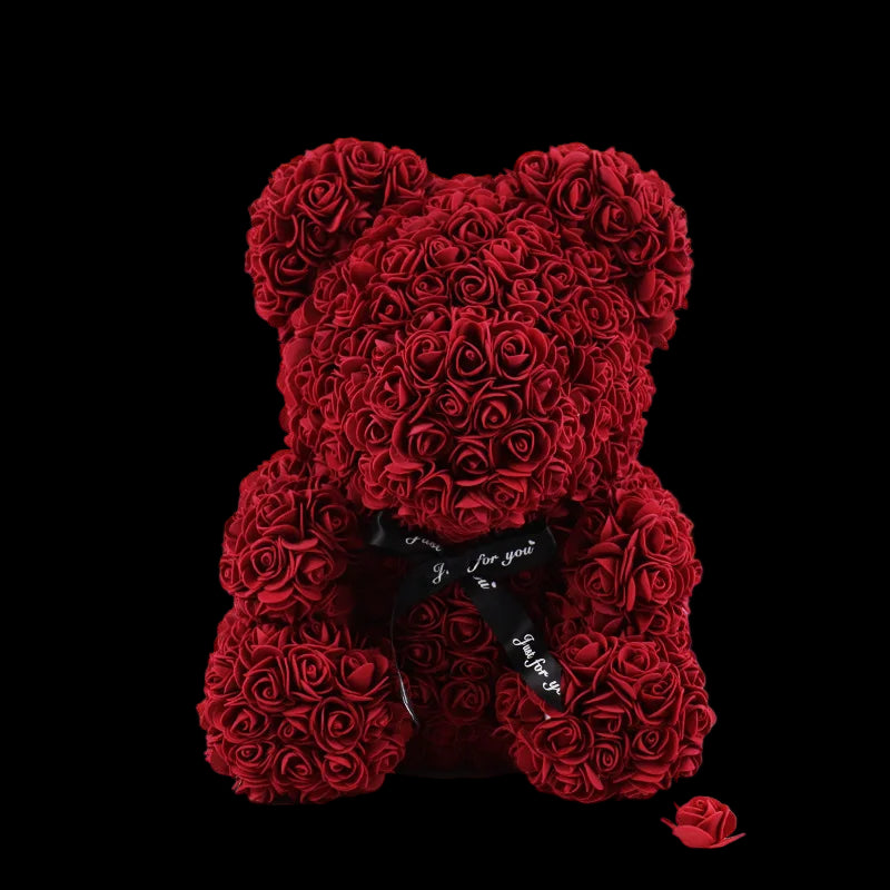 Red rose teddy bear with a bow on a white background