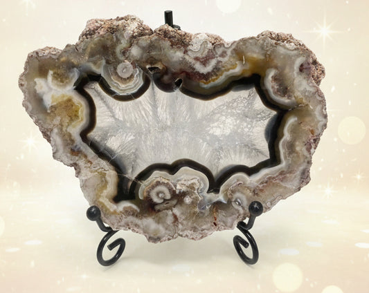Geode crystal on a stand with a white background