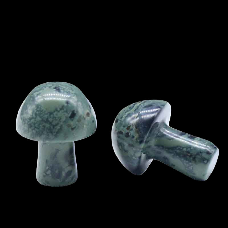 Two green stone mushrooms on a white background