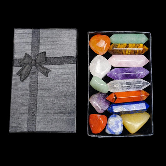 Set of colorful crystals in a box with a gray gift box on a white background