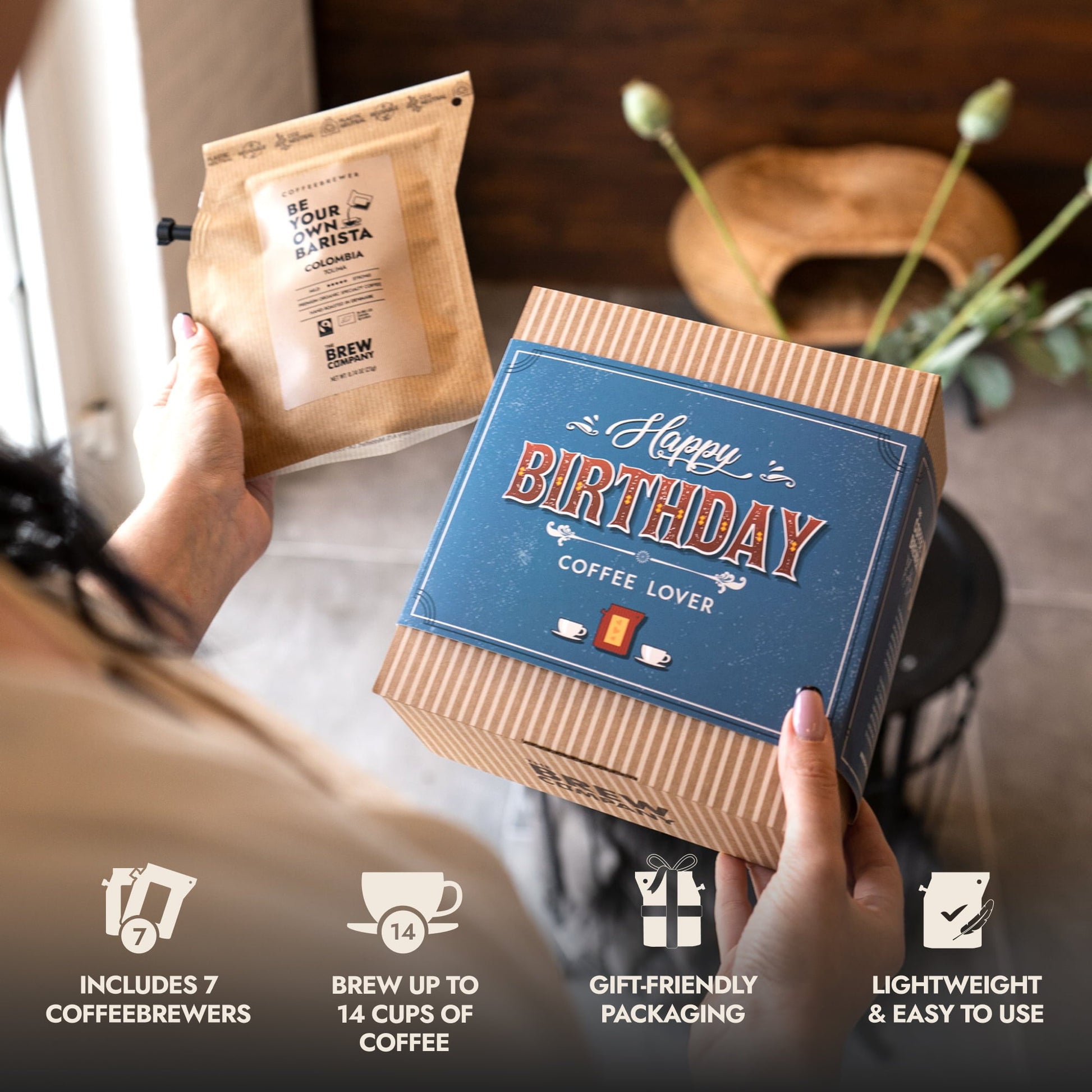 Person holding a 'Happy Birthday Coffee Lover' gift box with coffee package.