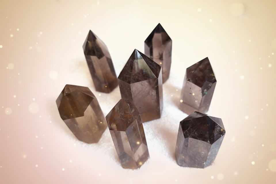 Set of eight smoky quartz crystal points on a white background