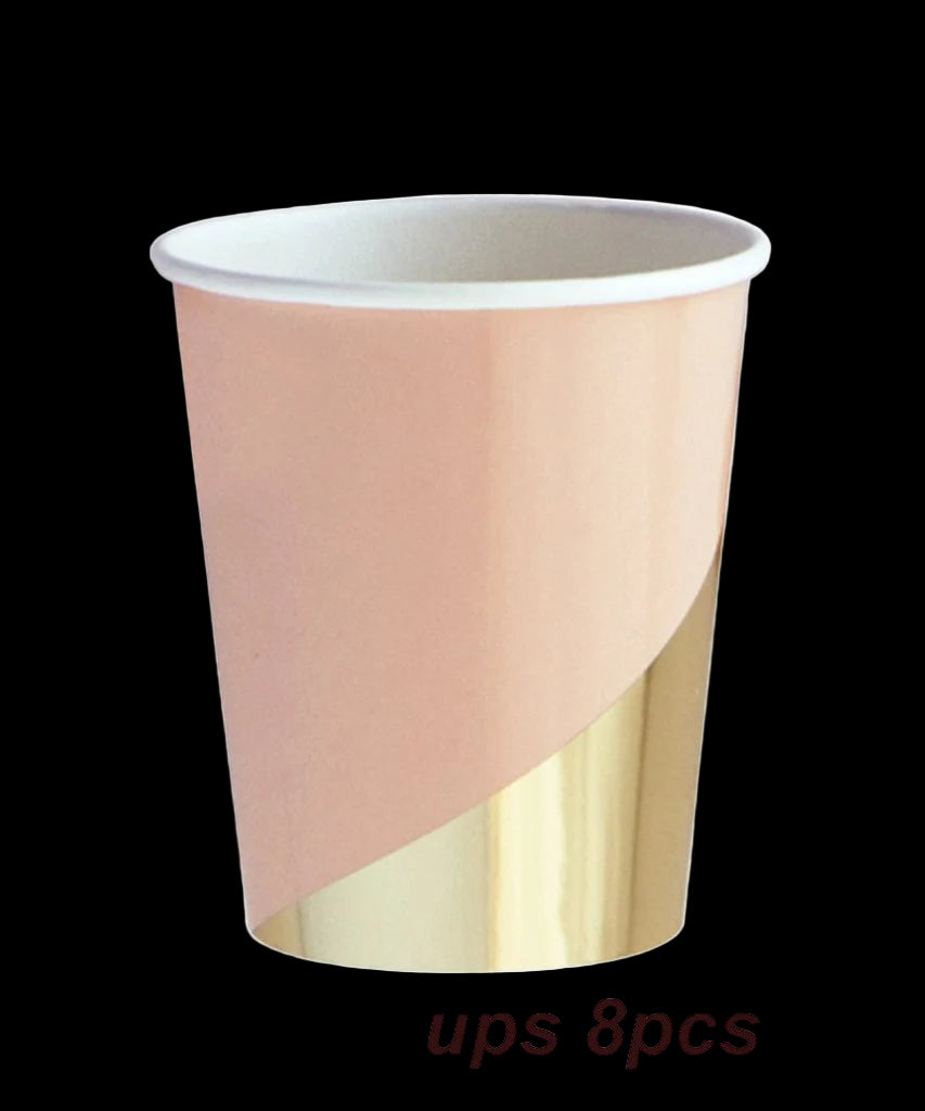 Paper cup with pink and gold design on a white background