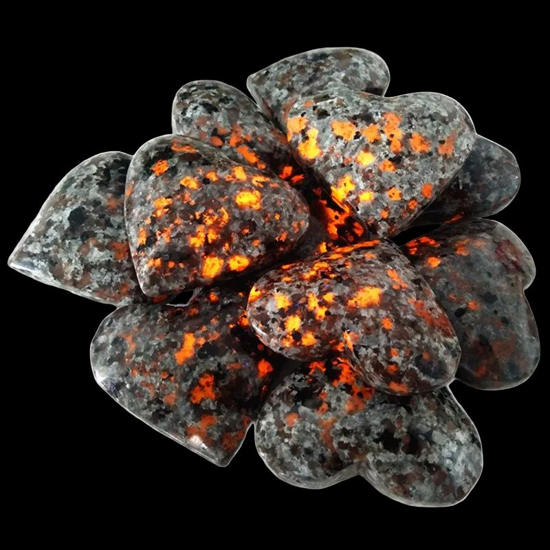 Cluster of gray stones with orange and red speckles on a white background