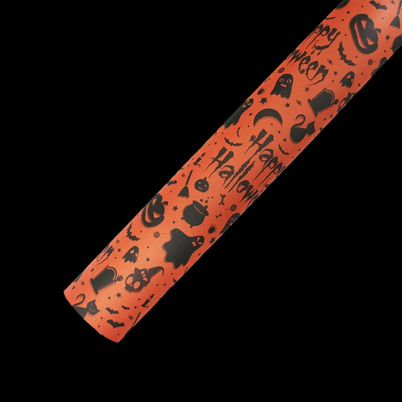 Halloween-themed decorative paper roll with black cutouts on an orange background
