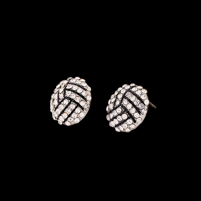 Pair of round earrings with black and silver design on a magazine