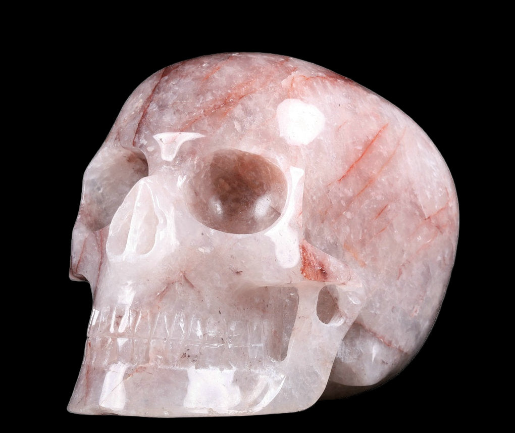 Pink stone skull sculpture on a white background