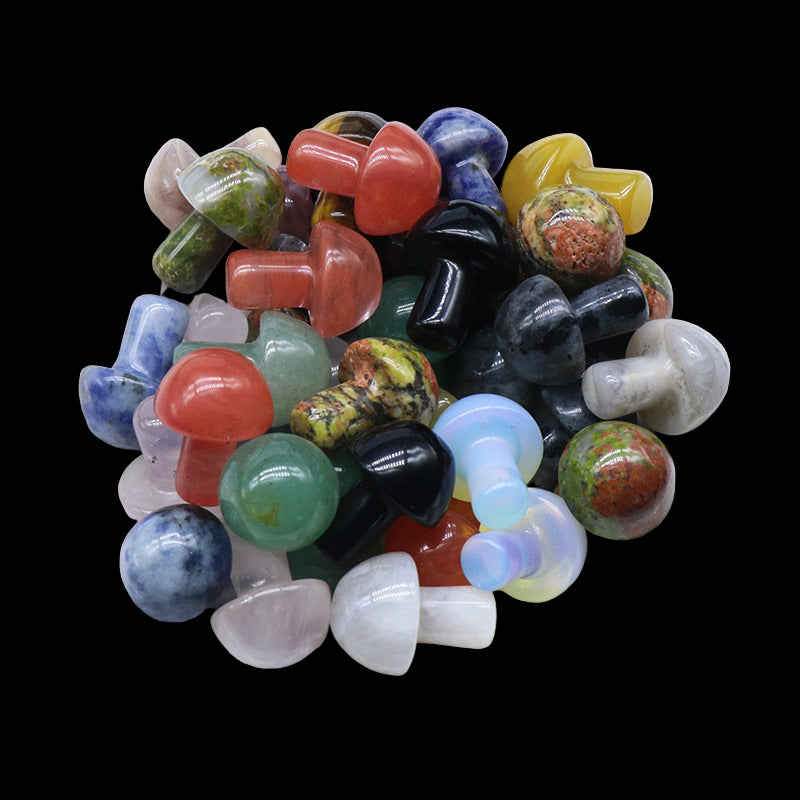 Assorted colorful gemstones in a white bowl on a light background
