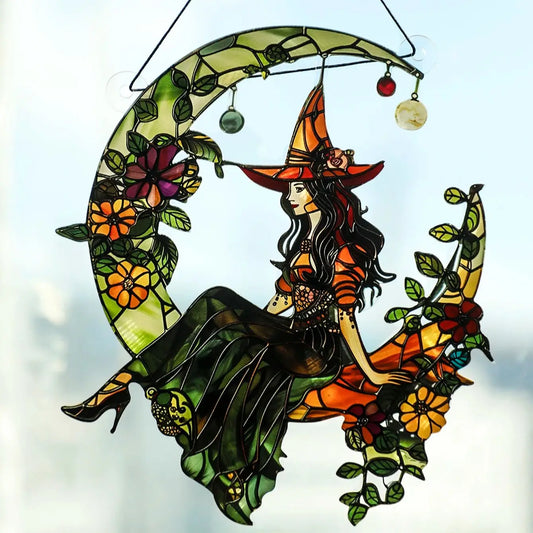Stained glass window hanging with a witch design on a white background