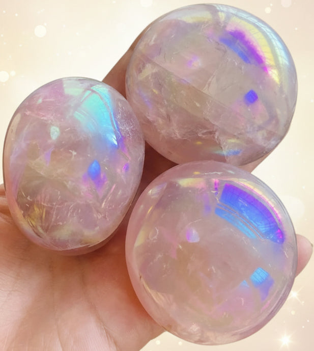 Three iridescent marbles held in a hand with a natural background