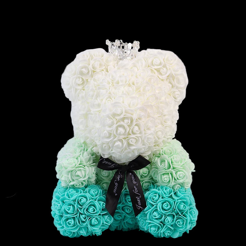 Floral teddy bear with a bow and tiara on a white background