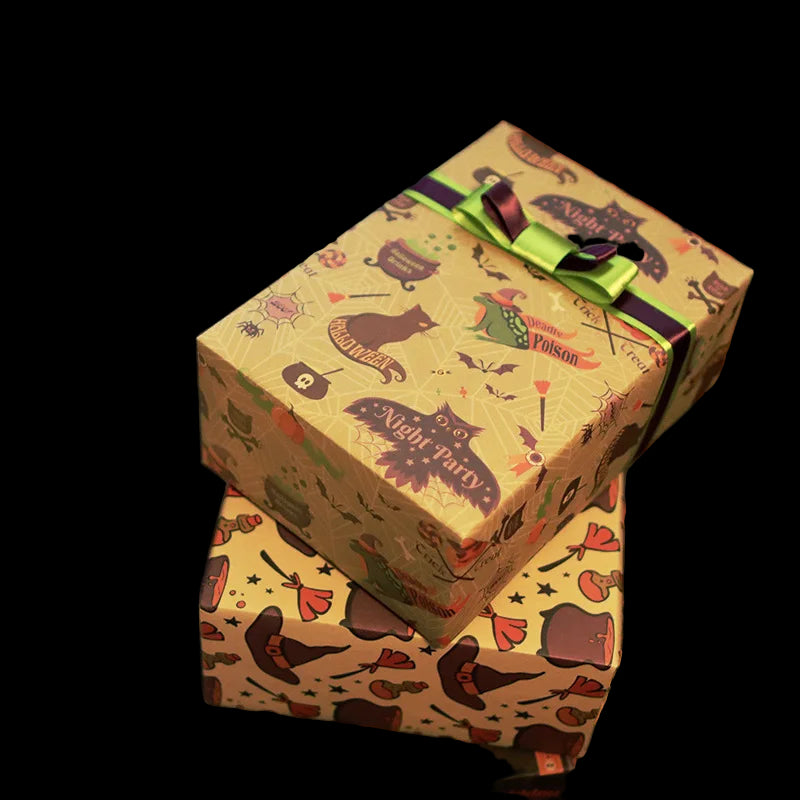 Stack of Halloween-themed gift boxes with decorative ribbons.