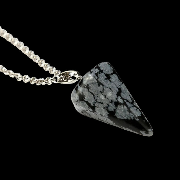 Triangular stone pendant on a chain against a white background