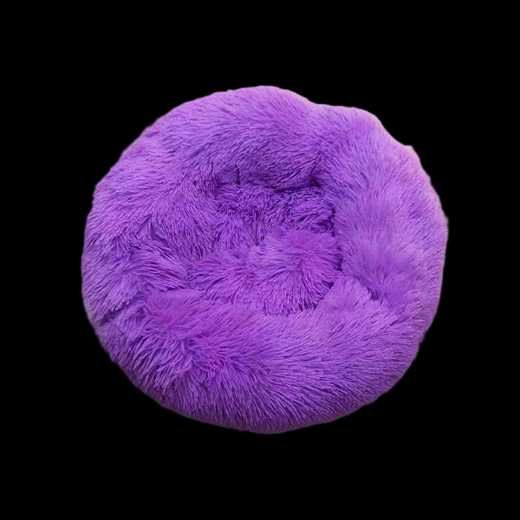 Purple fluffy pet bed on a gray background