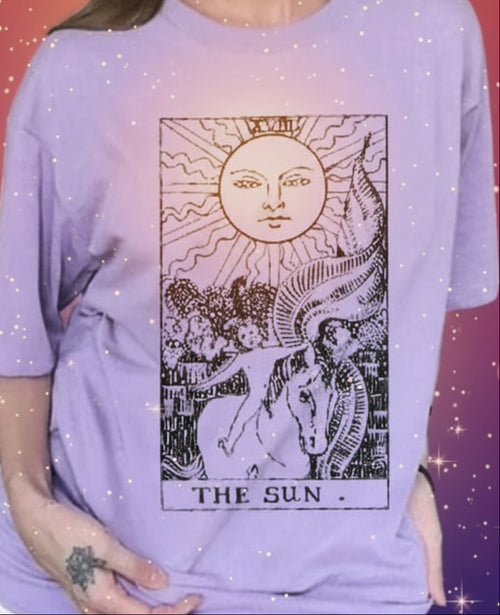 Person wearing a purple t-shirt with a graphic design in a room.