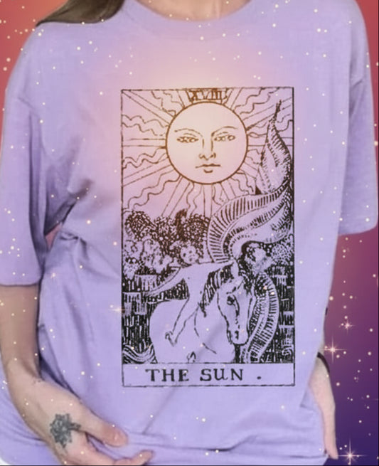 Person wearing a purple t-shirt with a graphic design in a room.