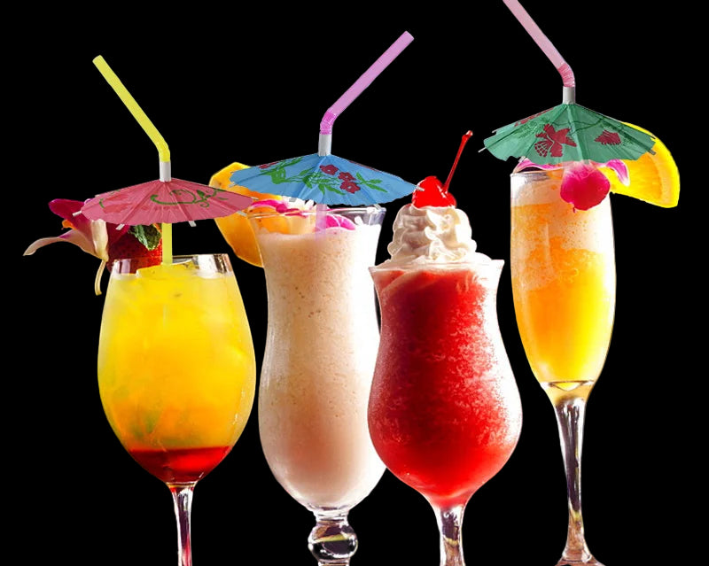 Four colorful cocktails with umbrellas on a wooden surface.