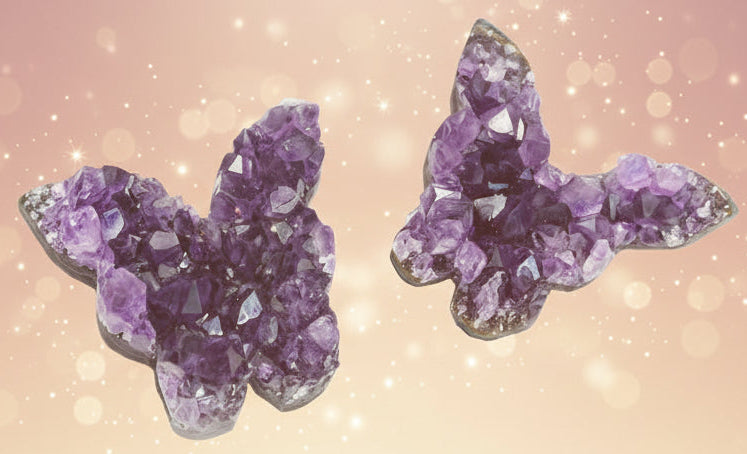 Purple crystal butterfly earrings on a white background