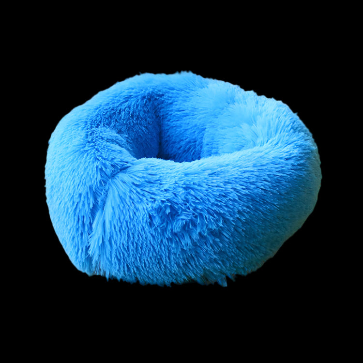 Blue fluffy donut pet bed on a yellow couch