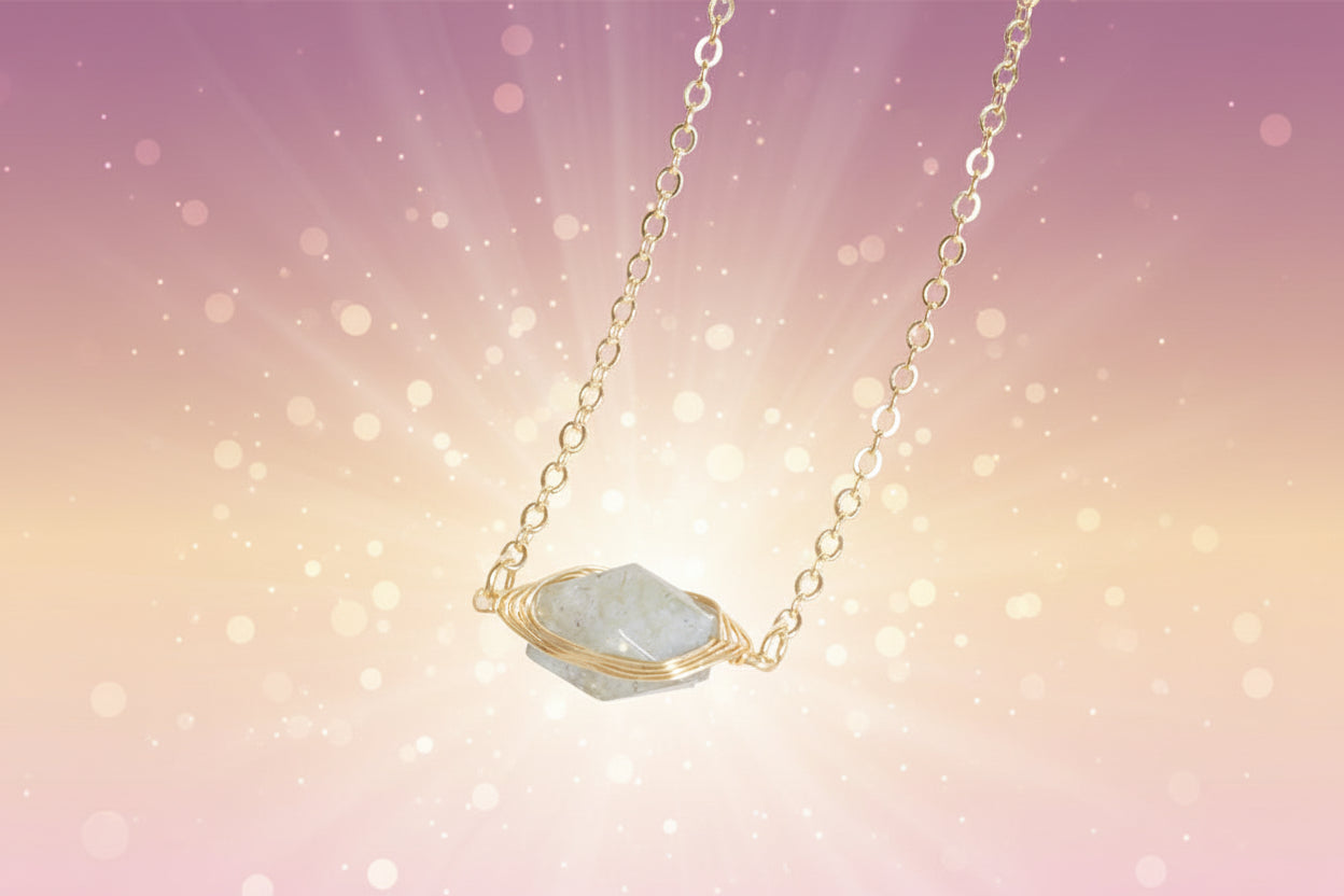 Necklace with a green stone pendant on a beige surface