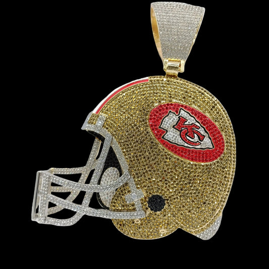 Gold helmet-shaped pendant with red and black logo on a white background