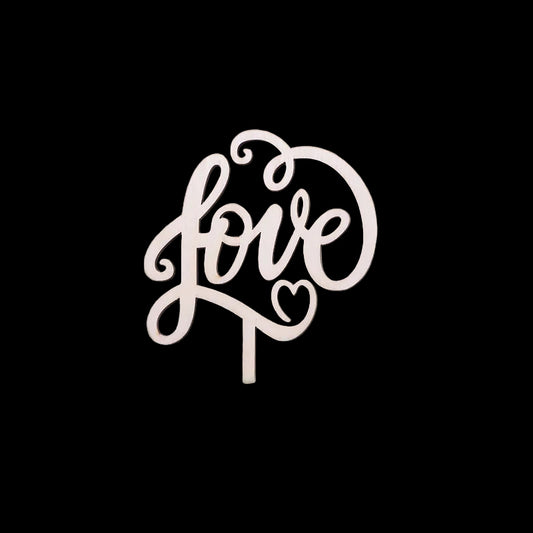 Wooden 'love' cake topper on a floral cake with a blurred background